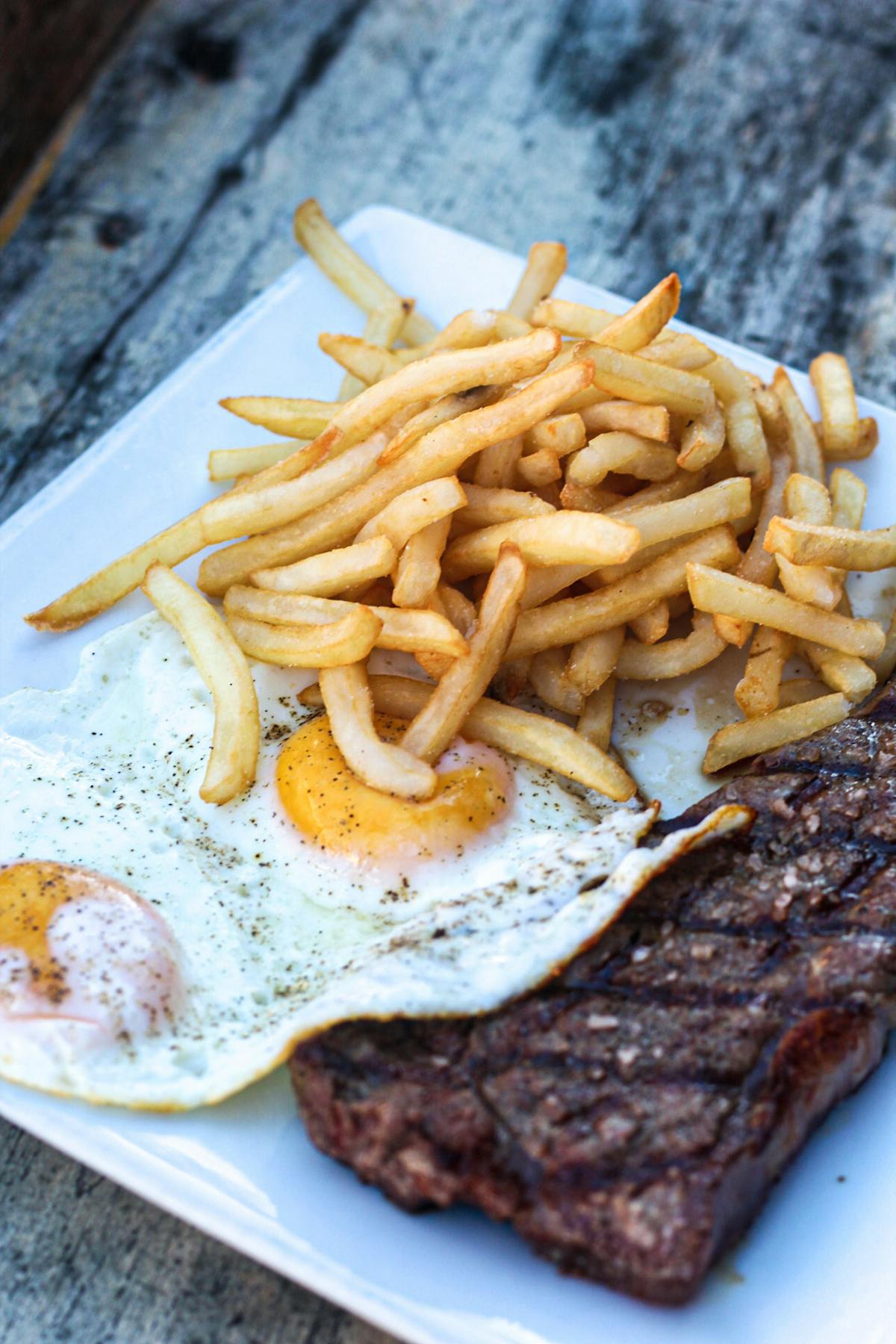 a close up of a plate of hot dogs and french fries